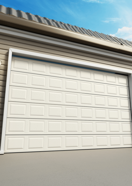 Cream sectional garage door on a building with a corrugated metal roof, viewed against a blue sky