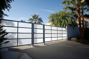 White horizontal-slat aluminium sliding driveway gate beside palm trees