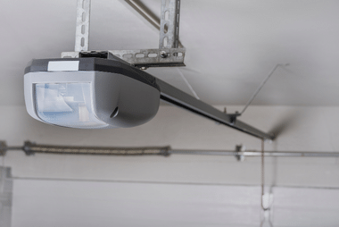 Garage door opener motor mounted on the ceiling rail